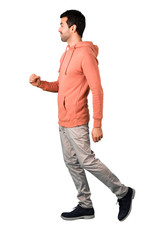 Naklejka premium Full body of Man in a pink sweatshirt walking. Motion gesture on isolated white background. Ideal for use in architectural designs
