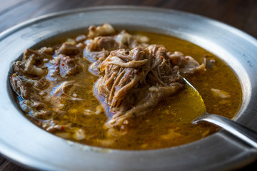Turkish Soup Beyran with Lamb Meat, Rice, Chopped Garlic and Vinegar Sauce Served with Salad.