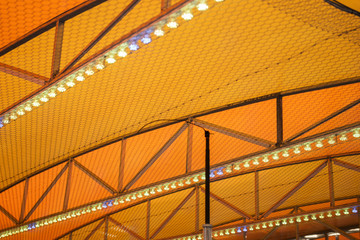 Different colored lights on the ceiling of the bumper car ride