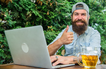 Football fan bearded hipster make bet sport game laptop. Guy sit terrace outdoors with beer....