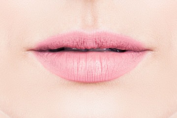 Gentle female lips with pink lipstick makeup