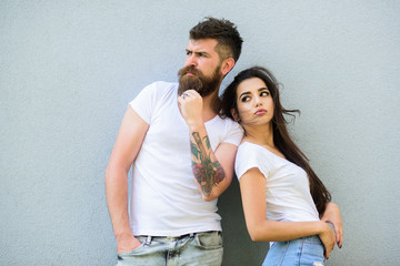 Naklejka premium Couple stylish youth. Couple white shirts cuddle each other. Romantic couple. Couple in love hang out together grey wall background. Hipster bearded and stylish girl hang out urban romantic date