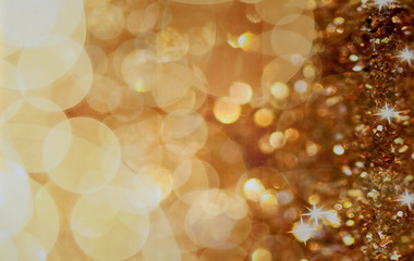 Christmas background. Golden holiday abstract glitter defocused background with blinking stars....