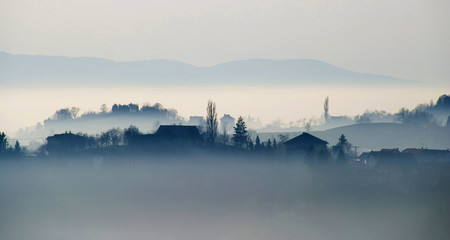 Small village with in the foggy horizon
