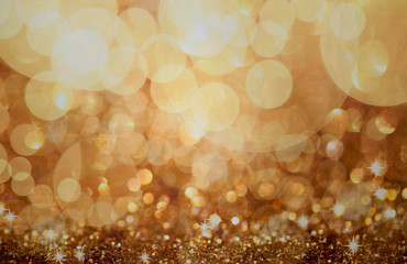 Christmas background. Golden holiday abstract glitter defocused background with blinking stars....