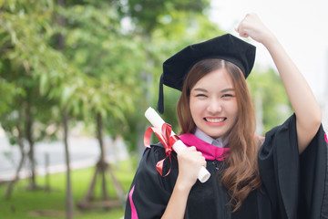 happy successful smiling woman university student graduating; portrait of diploma or college woman student with graduation degree, education concept; asian 20s young adult woman model