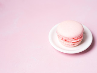 Pink colorful cake macaroon on pastel background, colorful almond cookies