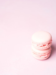 Pink colorful cake macaroon on pastel background, colorful almond cookies