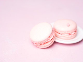 Pink colorful cake macaroon on pastel background, colorful almond cookies