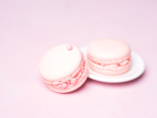 Pink colorful cake macaroon on pastel background, colorful almond cookies