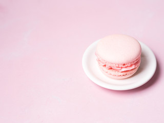 Pink colorful cake macaroon on pastel background, colorful almond cookies