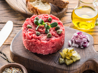 Steak tartare served with capers, pickled cucumbers and chopped onion.
