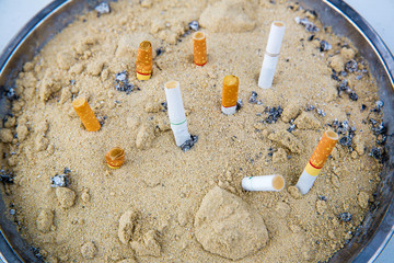 Close up cigarette ashtray. don't smoke concept. nicotine concept. health care and addictive...