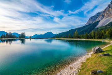 Fototapeta na wymiar A beautiful view on the Ehrwalder Almsee and the Zugspitze on a sunny summer day in Austria, September 2018