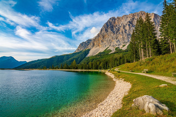 Naklejka na ściany i meble A beautiful view on the Ehrwalder Almsee and the Zugspitze on a sunny summer day in Austria, September 2018