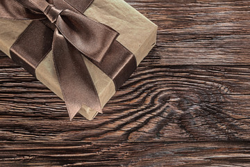 Brown gift box on vintage wooden board horizontal image