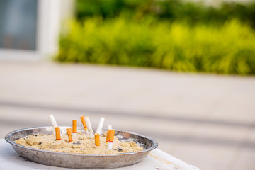 Close up cigarette ashtray. don't smoke concept. nicotine concept. health care and addictive substance. image for objects, no smoking are, no smoking campaign concept.