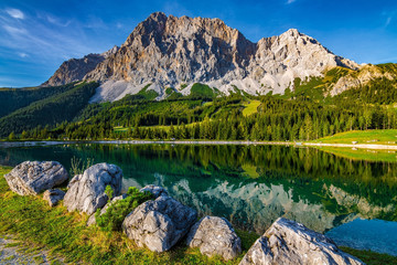 A beautiful view on the Ehrwalder Almsee and the Zugspitze on a sunny summer day in Austria, September 2018 - obrazy, fototapety, plakaty