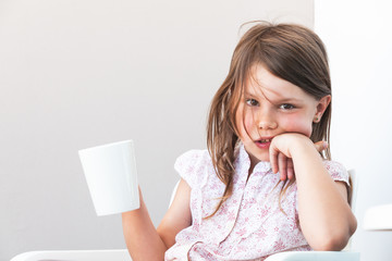 Portrait of little girl with cup of hot chocolate