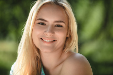 Close up portrait of sweet blonde woman. Attractive female with sweet gorgeous smile looking directly into camera and grining.