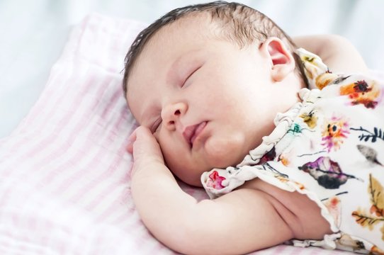 Sweet Caucasian newborn baby sleeping concept image.