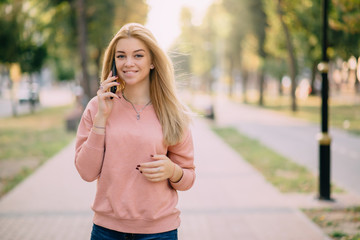 young girl speaks on phone outdoor