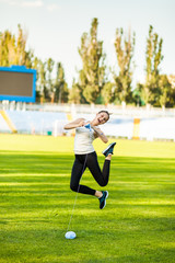 Woman athlete knitting a sweater on a football field