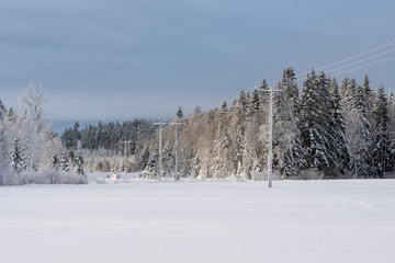 Power lines crossing a winter landscape in Sweden