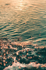 water surface with drops and splashes in the sunset and turquoise water  