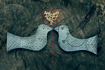 love card / two wooden birds and heart made of seeds on the wooden background with inscription love you /Valentine