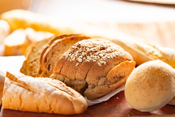 Close up mixed Sweet bread home made on wooden table after baked,Selective focus,Warm tone