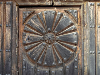 Fototapeta na wymiar Details of the wooden door of the Church of Santa Maria - Boadilla del Camino, Castile and Leon, Spain