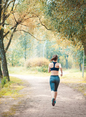 Active beautiful woman running in the park. Healthy lifestyle