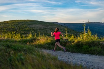 Young woman cross running in the mountains.