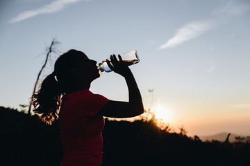 Woman drinking water from the bottle