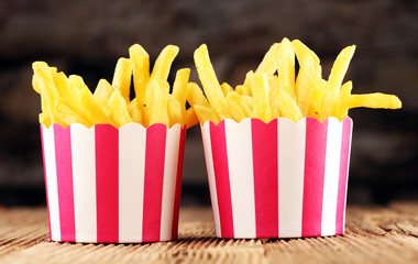 Potatoes French Fries in Red and white Carton Package Box. Fast Food.