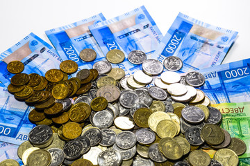 Russian banknotes and coins. A handful of coins on new Russian banknotes in denominations of 2000...