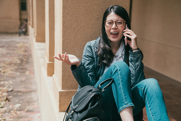 student talking in phone and looking cheerfully