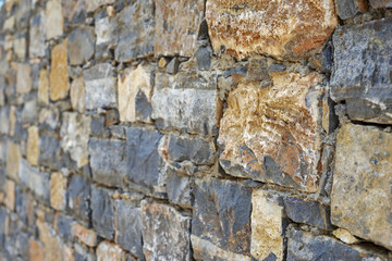 Part of grunge colorful stone blocks wall.