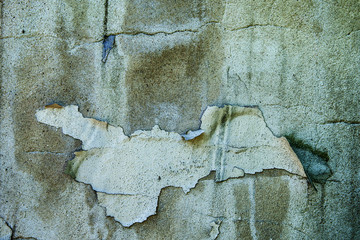 Grunge old concrete wall with peeling paint.