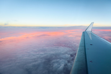 Looking trough aircraft window at the airplane wing.