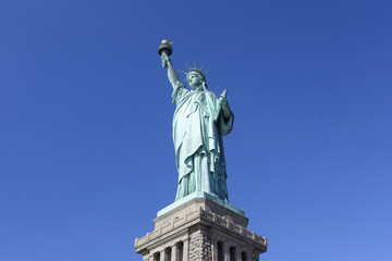 Fototapeta na wymiar Statue of Liberty iconic landmark and tourist attraction place of New York city NYC USA American symbol stand in clear deep blue sky background of good weather day ant eyes view