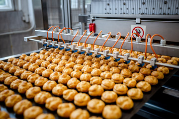 Profitrols on a conveyor belt at a bakery plant