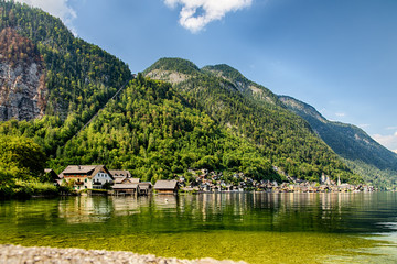 View of the mountains, lake and forest at Hallstatt village in Austria, with salt mine in the background. Buildings and houses