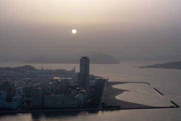 Fototapeta premium View of Kitakyushu City by the sea around Wakamatsu-ku in summer time.