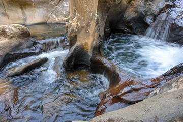Fototapeta na wymiar Small creek with clear waters running through the rocks of the mountains of Minas Gerais