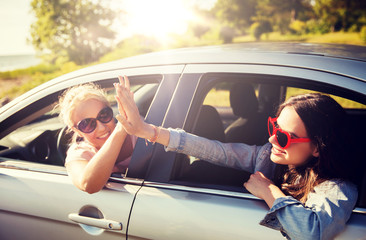 summer vacation, holidays, travel, road trip and people concept - happy teenage girls or young...