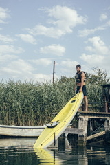 Man Holding a Kayak