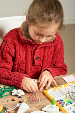 Childrens making decorations for new year holiday. Painting watercolors. Top view. Artwork workplace with creative accessories.