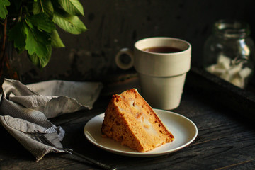 cake a piece, with cream on a white plate. Top view rosemary. food background